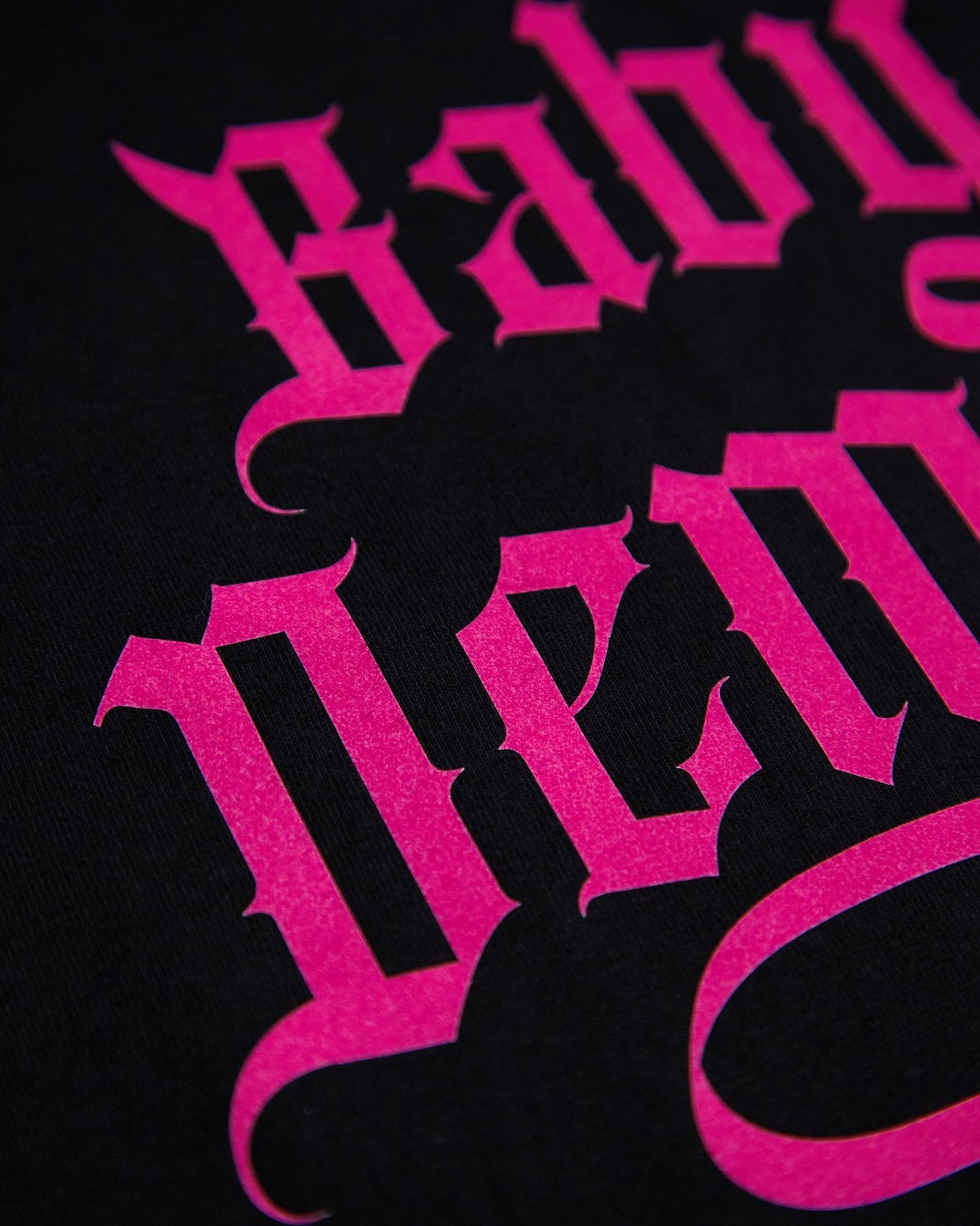 Baby Demon, pink flock on black muscle fit tee.